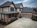 Beautiful two-story home with a two-car garage and covered porch at 6310 Talking Tree Ct, Cumming, GA 30028
