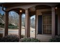 Inviting front porch with stately columns, offering a cozy outdoor space at 6310 Talking Tree Ct, Cumming, GA 30028