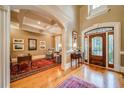 Grand foyer showcasing hardwood floors, high ceilings, and a decorative front door at 9070 Huntcliff Trce, Sandy Springs, GA 30350