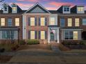 Attractive brick townhome exterior illuminated at dusk at 256 S Village Sq, Canton, GA 30115