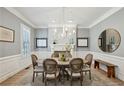 Charming dining room with a fireplace, chandelier, and wainscoting at 835 Springside Ne Ct, Atlanta, GA 30342