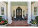 Inviting front porch with double doors, rocking chairs, and planters at 835 Springside Ne Ct, Atlanta, GA 30342
