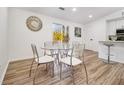 Dining area featuring a glass table set, bright natural light, and modern finishes at 1428 Muirfield Dr, Stone Mountain, GA 30088