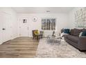 Bright living room with a modern design including a stylish grey sofa and eye-catching rug at 1428 Muirfield Dr, Stone Mountain, GA 30088