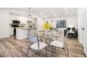 Open floor plan featuring a modern kitchen overlooking the dining and living areas at 1428 Muirfield Dr, Stone Mountain, GA 30088