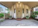 Front entrance with covered porch, decorative details, and manicured plants at 6 Arden Moor Nw, Atlanta, GA 30305