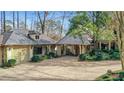 View of the charming home with a detached garage and covered portico at 6 Arden Moor Nw, Atlanta, GA 30305