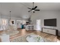 Open-concept living area featuring modern lighting, a kitchen island, and hardwood floors at 835 Old Brock Rd, Rockmart, GA 30153