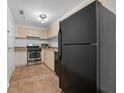 Galley kitchen with stainless steel appliances and light cabinets at 1501 Clairmont Rd # 223, Decatur, GA 30033