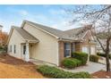 Well-maintained home with a combination of brick and siding, complemented by green shrubs and a two-car garage at 407 Red Coat Ln, Woodstock, GA 30188