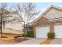 Lovely brick home with a two-car garage, a neat lawn, and a welcoming facade at 407 Red Coat Ln, Woodstock, GA 30188
