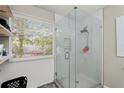 Shower stall featuring glass doors, a shower head, and tile surround at 5076 Furlong Way, Powder Springs, GA 30127