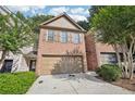 Two-story brick townhome with a 2-car garage at 718 Surrey Park Se Pl, Smyrna, GA 30082