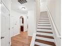 Hardwood staircase with white risers and neutral walls at 718 Surrey Park Se Pl, Smyrna, GA 30082