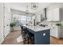 Modern kitchen featuring white cabinets, an island with bar seating, and stainless-steel appliances at 720 Perch Pl, Atlanta, GA 30312