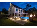 Expansive backyard featuring a pool, spa, lounge area, and fire pit, ideal for entertaining at 100 Chateau Pl, Woodstock, GA 30188