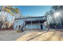 Back exterior view of home with deck and stairs at 791 Cross Plains Hulett Rd, Carrollton, GA 30116