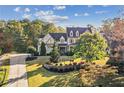 Beautiful home with a circular driveway and lush landscaping, creating a welcoming and picturesque setting at 5021 Heatherwood Ct, Roswell, GA 30075