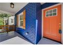 Modern orange front door with stylish hardware at 1565 Ocala Sw Ave, Atlanta, GA 30311