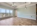 Spacious living room features tray ceiling, modern ceiling fan, and large window with treetop views at 4333 Dunwoody Park Dr # 3406, Dunwoody, GA 30338