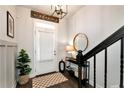 Elegant entryway features a stylish mirror, decorative table, and staircase with a black banister at 532 Sonata Walk, Marietta, GA 30067