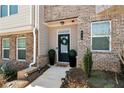 Inviting townhome entrance featuring brick accents, manicured greenery, and a stylish front door at 532 Sonata Walk, Marietta, GA 30067