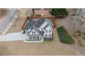 Aerial view of home with manicured lawn, dark roof, and fenced backyard at 100 Cottonwood Pl, Stockbridge, GA 30281