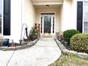 Inviting front entrance with decorative plants and walkway at 100 Cottonwood Pl, Stockbridge, GA 30281