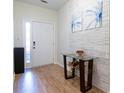 Inviting entryway with stylish decor, featuring modern art on the stone accent wall and wood-look floors at 1605 Signal Flag Way, Lawrenceville, GA 30043