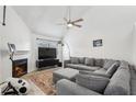 Spacious living room featuring vaulted ceilings, a cozy fireplace, and plush gray sectional sofa at 1403 Parkaire Xing, Marietta, GA 30068