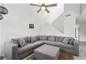 Cozy living area featuring a large gray sectional sofa, high ceilings, and natural light at 1403 Parkaire Xing, Marietta, GA 30068