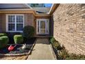 Charming brick home entrance featuring a well-manicured garden and pathway leading to the front door at 3710 Blackgold Dr, Buford, GA 30519