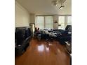 Spacious living room with hardwood floors and large TV at 57 Forsyth St Nw Apt 6E Nw St # 6E, Atlanta, GA 30303