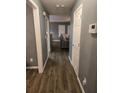 Gray hallway with wood-look flooring leading to living room at 7533 Congregation St, Fairburn, GA 30213