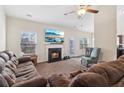 Inviting living room featuring a cozy fireplace, plush seating, and ample natural light at 612 Cole Creek Dr, Dallas, GA 30157