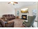 Inviting living room featuring a cozy fireplace, plush seating, and ample natural light at 612 Cole Creek Dr, Dallas, GA 30157