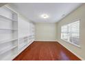 Spacious bedroom featuring built-in shelving and a large window for ample natural light at 275 Creek View Ln, Acworth, GA 30102