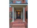 Elegant front entrance with a black door, brick steps, and columned portico at 561 Congress Pkwy, Lawrenceville, GA 30044