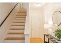 Bright stairway with wood treads and white risers, adjacent to modern table and round mirror at 4826 Liberty Plz, Acworth, GA 30101