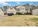 Two-story house with attached garage and landscaped lawn at 7483 Pleasant Hill Rd, Lithonia, GA 30058