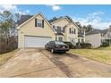 Two-story house with attached garage and driveway at 7483 Pleasant Hill Rd, Lithonia, GA 30058
