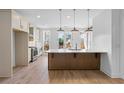 Modern kitchen featuring stainless steel appliances, quartz countertops, and wood grain vinyl flooring at 2531 High Brow St # 41, Duluth, GA 30096