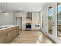 Modern kitchen featuring stainless steel appliances, island, and access to the deck at 2531 High Brow St # 41, Duluth, GA 30096