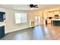 Bright living room open to the kitchen, featuring wood floors and a fireplace at 339 Garnet Dr, Acworth, GA 30101