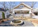 Charming home with a welcoming front porch, stone accents, and a water fountain at 536 Moreland Ne Ave, Atlanta, GA 30307