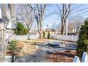 Landscaped front yard with a water fountain, fresh greenery, and a charming white picket fence at 536 Moreland Ne Ave, Atlanta, GA 30307