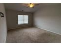 Bedroom with neutral carpet, a ceiling fan, and a window with horizontal blinds at 7540 Knoll Hollow Rd, Lithonia, GA 30058