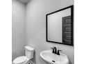 Modern bathroom with white fixtures, a sleek sink, and a black framed mirror at 202 Scenic View, Carrollton, GA 30116