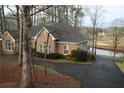 Elegant brick home with well-manicured landscaping, a private driveway, and scenic views of the golf course at 3711 Club Nw Dr, Kennesaw, GA 30144