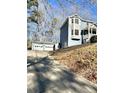 View of house and detached two car garage with white garage doors at 2610 Woodridge Chase, Canton, GA 30114